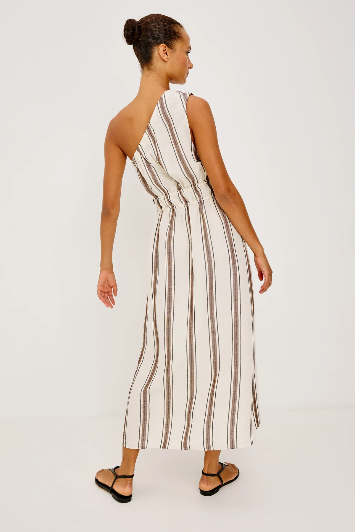 Woman wearing a striped jumpsuit on a white background