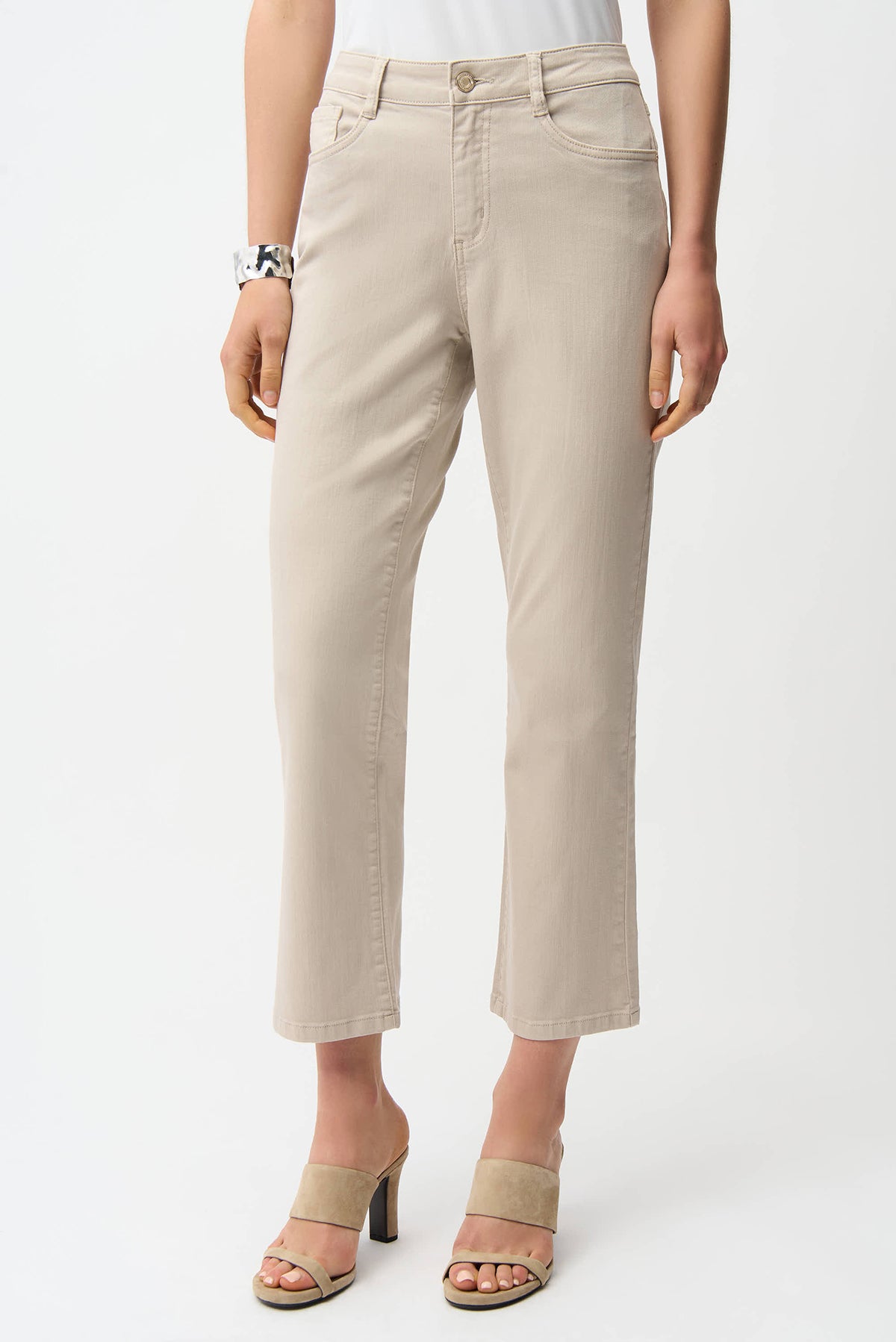 Beige pants worn by a person on a white background
