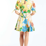 Woman wearing a colorful floral dress on a white background