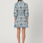 Woman wearing a patterned dress on a white background back view