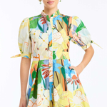 Woman wearing a colorful floral dress on a white background