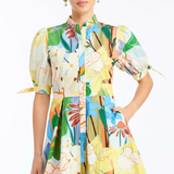 Woman wearing a colorful floral dress on a white background
