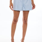woman in blue shorts on white background 