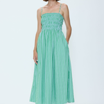 Woman wearing a green striped dress on a white background