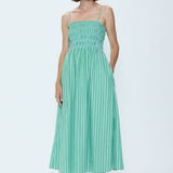Woman wearing a green striped dress on a white background