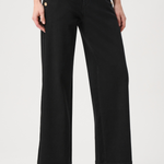 Model wearing dark-wash wide-leg jeans with sailor-inspired button detailing at the waist.
