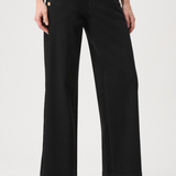 Model wearing dark-wash wide-leg jeans with sailor-inspired button detailing at the waist.
