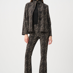 Woman wearing a black and white patterned suit on a white background
