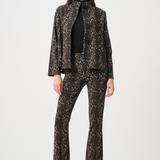 Woman wearing a black and white patterned suit on a white background