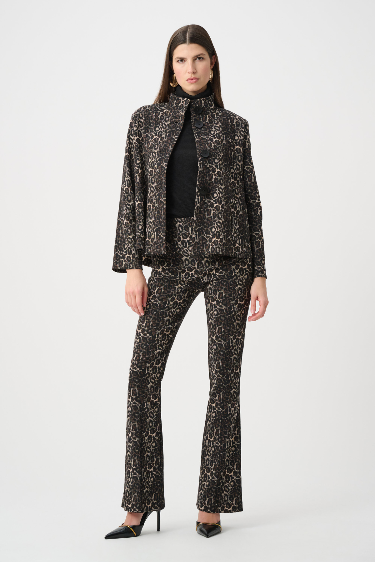 Woman wearing a black and white patterned suit on a white background