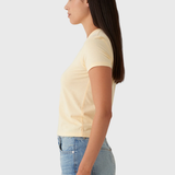 Woman wearing a light yellow t-shirt and denim shorts on a white background