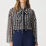 Model wearing a long-sleeve chiffon blouse with a geometric print and tie-neck detail in a relaxed, feminine silhouette.