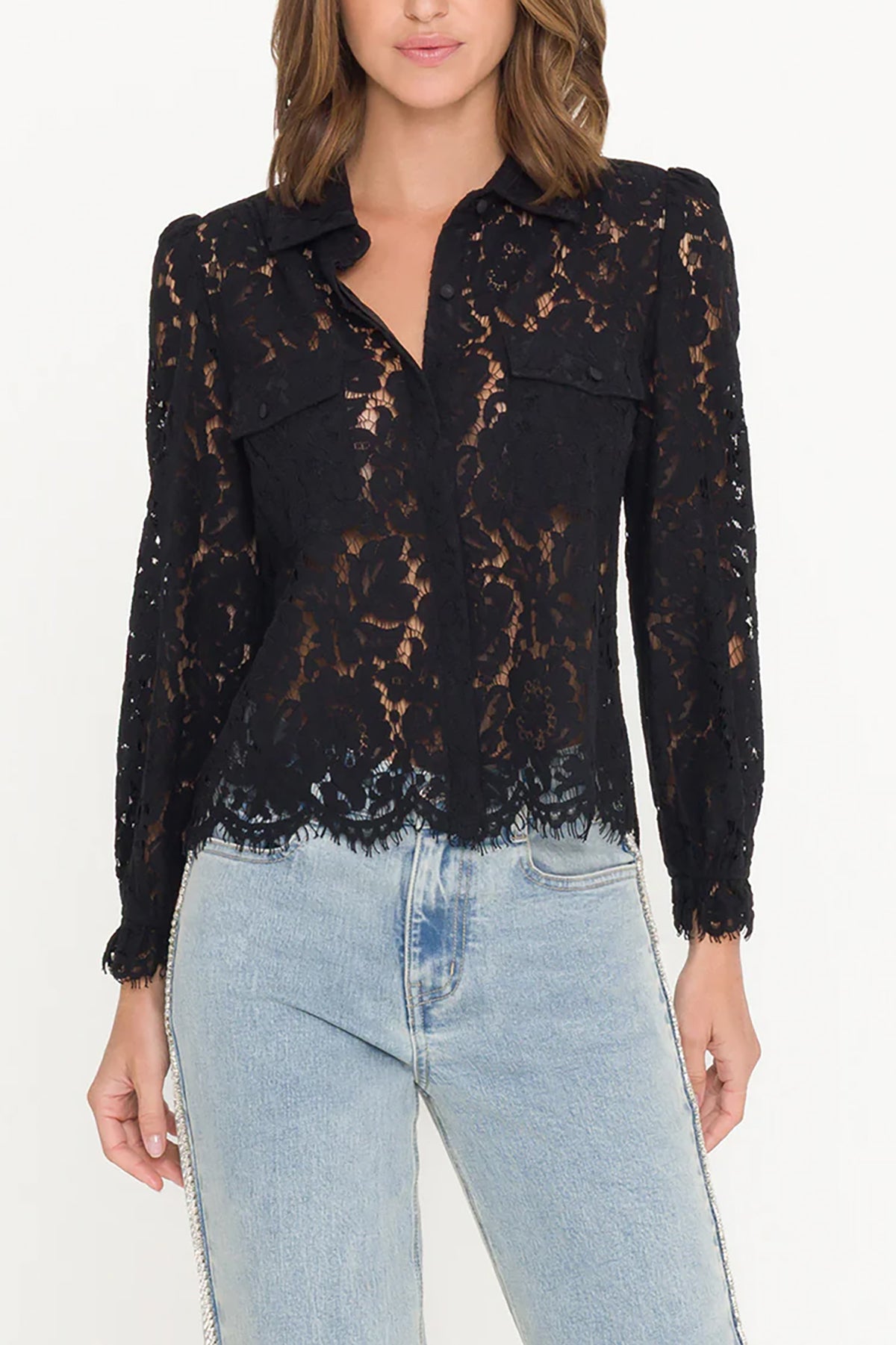 Black lace blouse worn by a person with light blue jeans on a white background