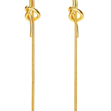 A pair of gold-toned drop earrings with a knotted detail at the top and long textured dangling chains, shown on a plain white background.