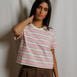 Woman wearing a striped shirt against a plain background