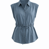 Blue sleeveless shirt with a tie waist on a white background