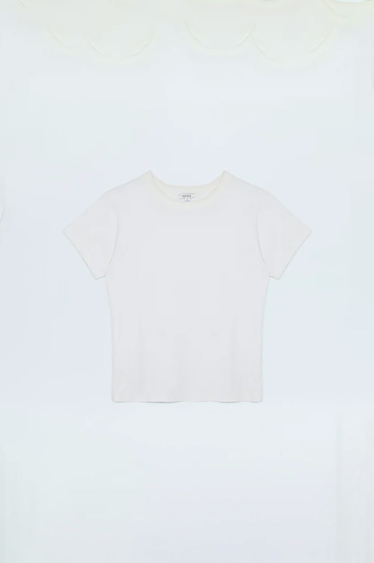 Minimal white top with a clean neckline and streamlined fit.