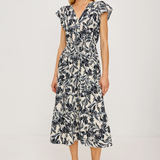 Woman wearing a black and white floral dress on a white background