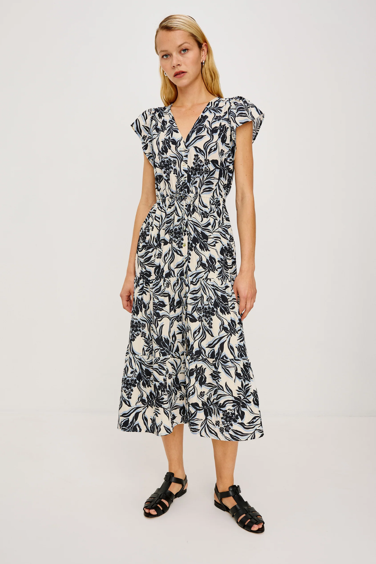 Woman wearing a black and white floral dress on a white background