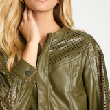 Woman wearing a green leather jacket with cut-out details on a white background