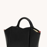Black Hammitt Paul Mini crossbody bag worn with an evening outfit.