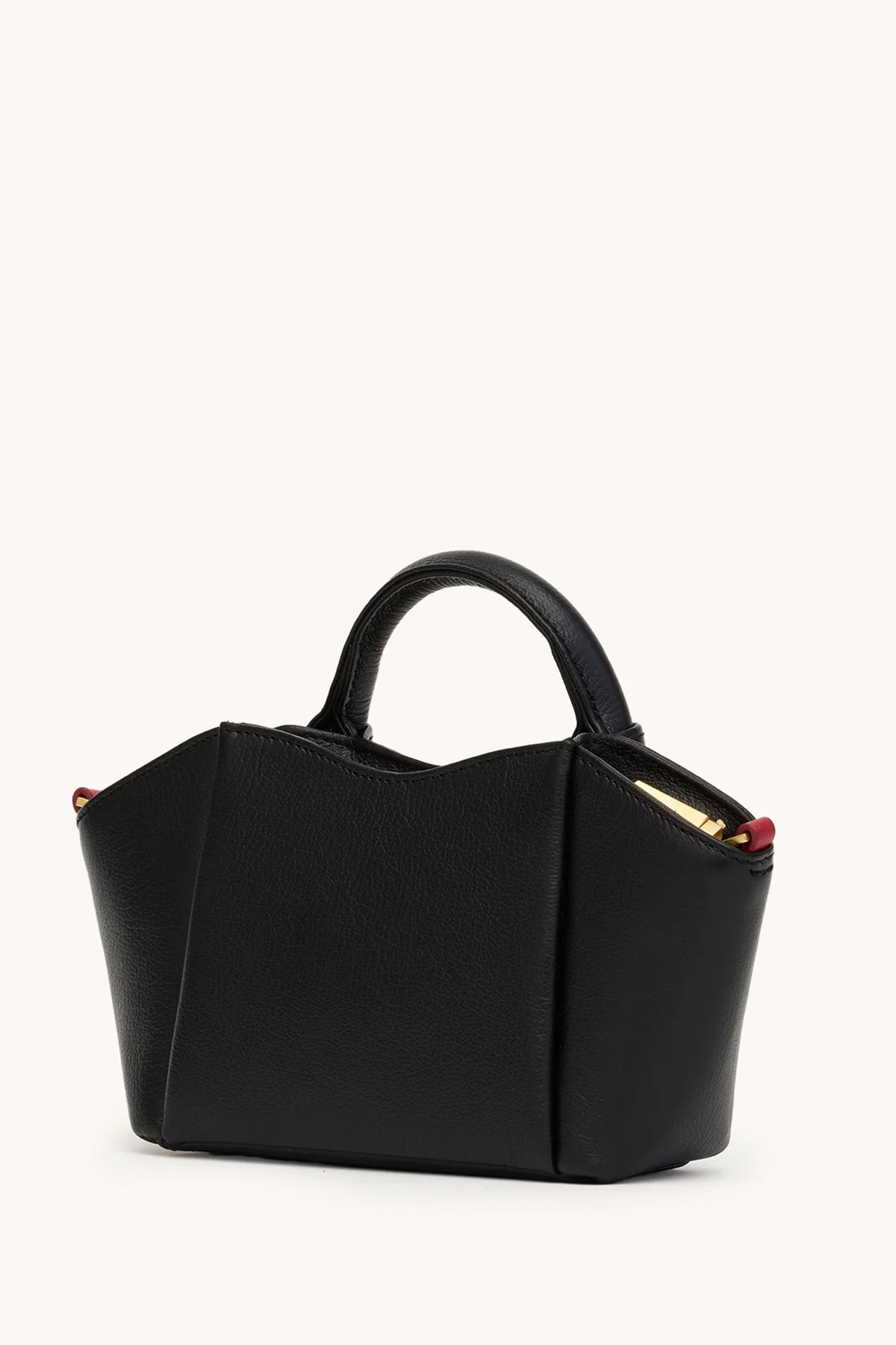 Black Hammitt Paul Mini crossbody bag worn with an evening outfit.