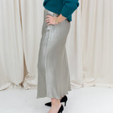 silky slip skirt with a soft drape, styled with a sweater