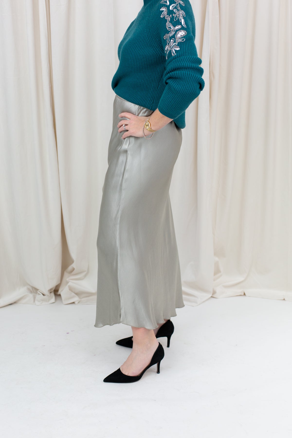 silky slip skirt with a soft drape, styled with a sweater