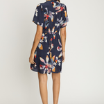 Woman wearing a floral dress on a white background