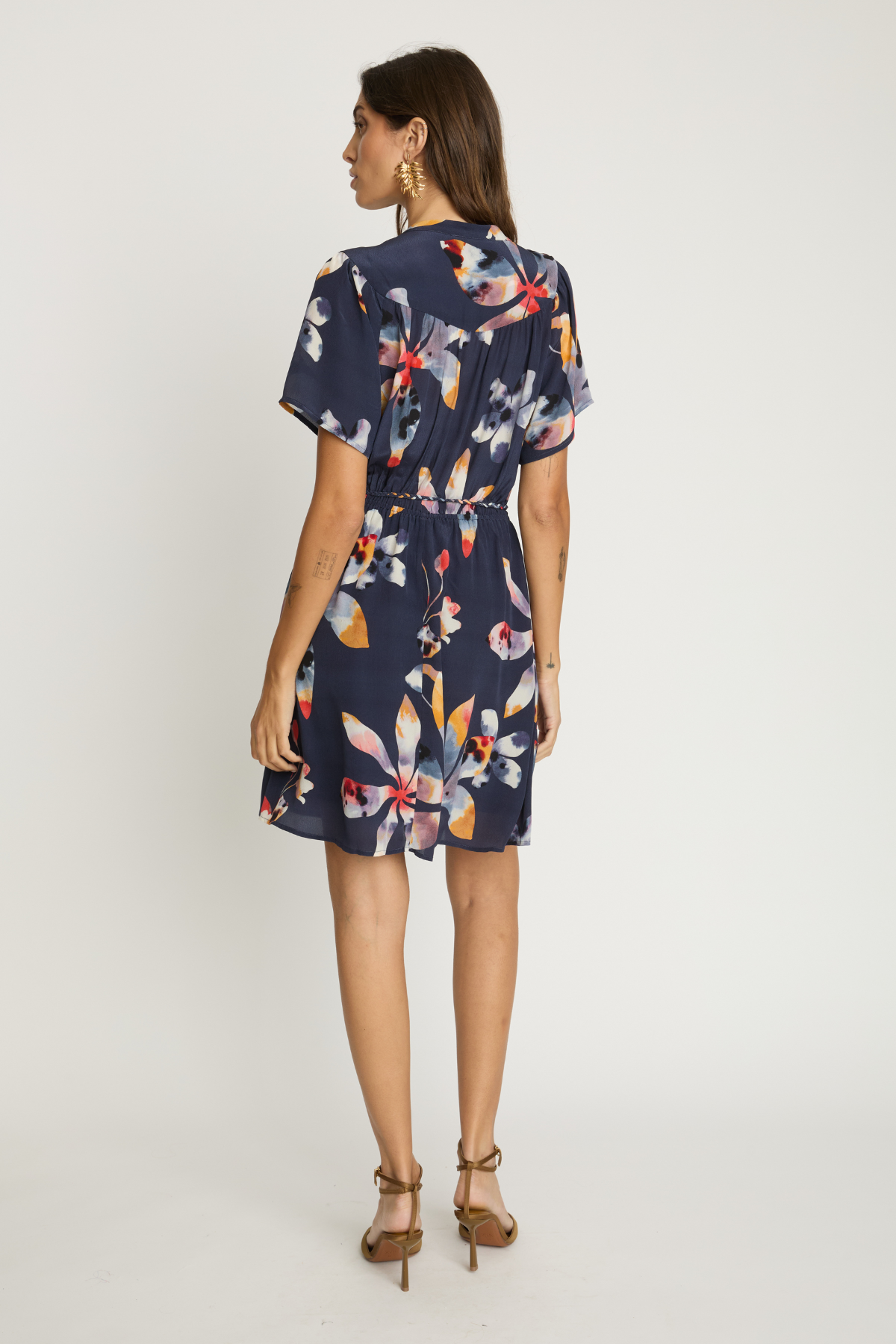 Woman wearing a floral dress on a white background