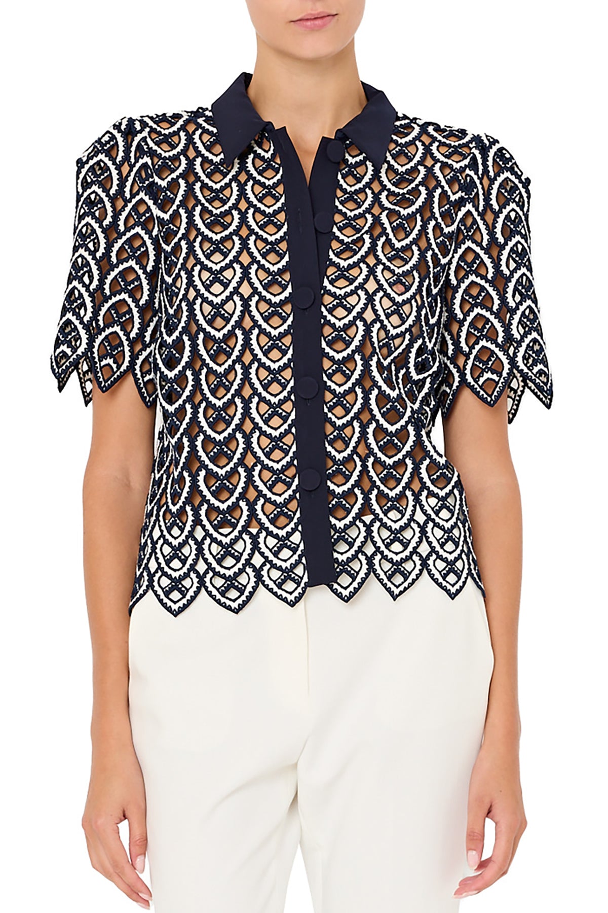 Woman wearing a patterned blouse with a white background