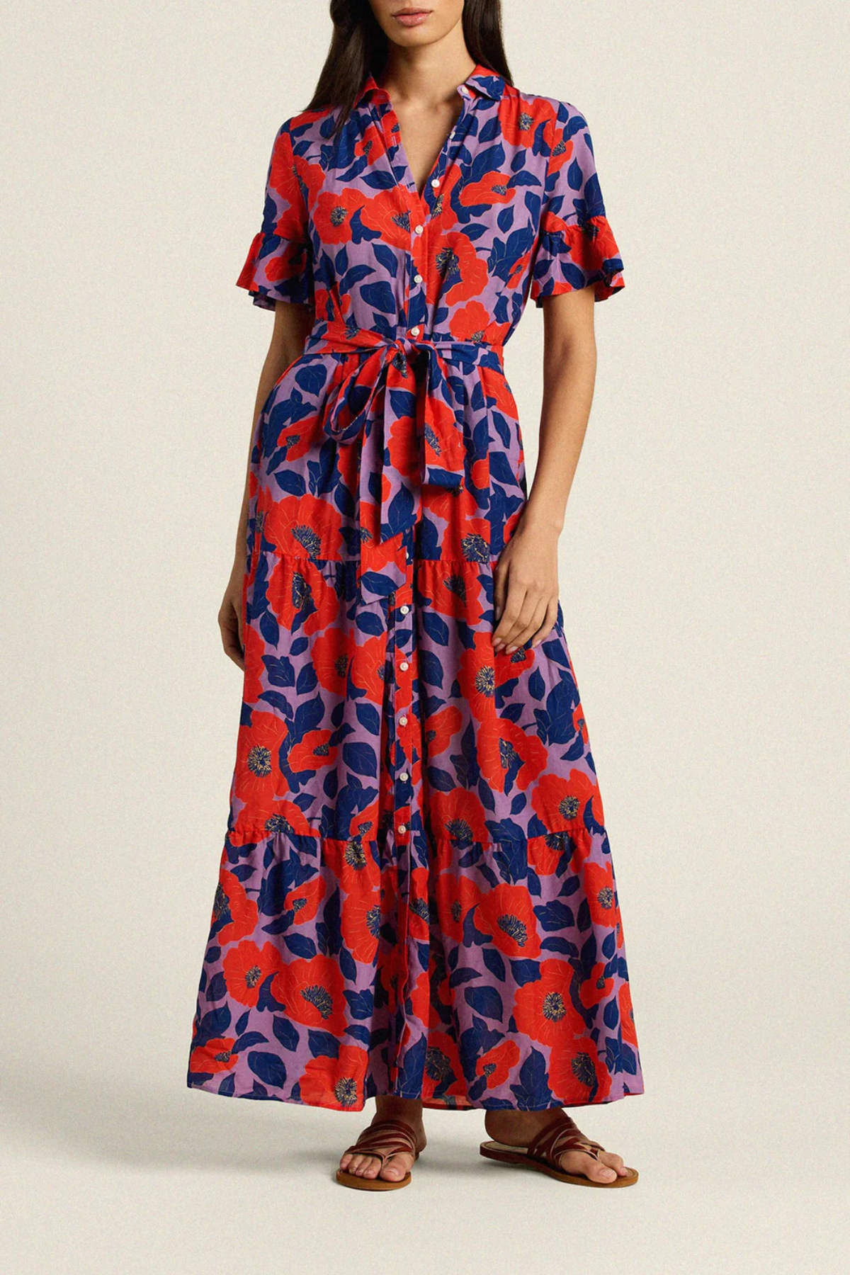 Woman wearing a red and blue patterned dress on a beige background