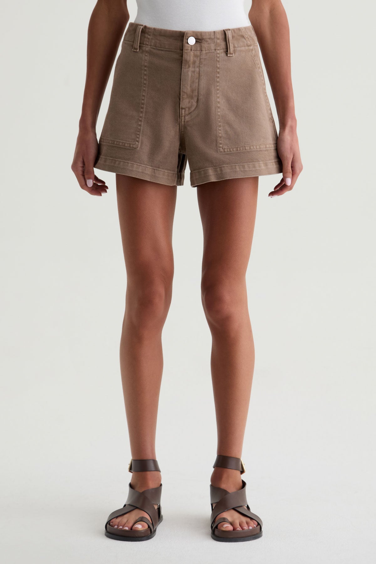 Person wearing brown shorts on a white background