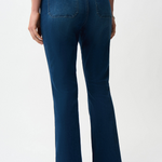 Person wearing blue jeans on a white background