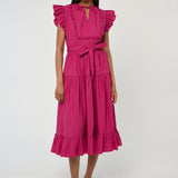 Woman wearing a vibrant pink sleeveless midi dress with soft tailoring and fluid drape.