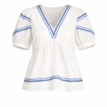 White blouse with blue embroidery on a white background