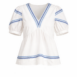 White blouse with blue embroidery on a white background