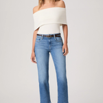 Woman wearing a white off-shoulder top and blue jeans on a white background