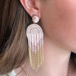 Model wearing beaded and chain detail earrings.