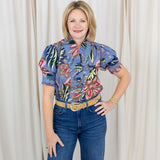 Woman wearing a short sleeve printed blouse in blue tones with an easy, relaxed fit