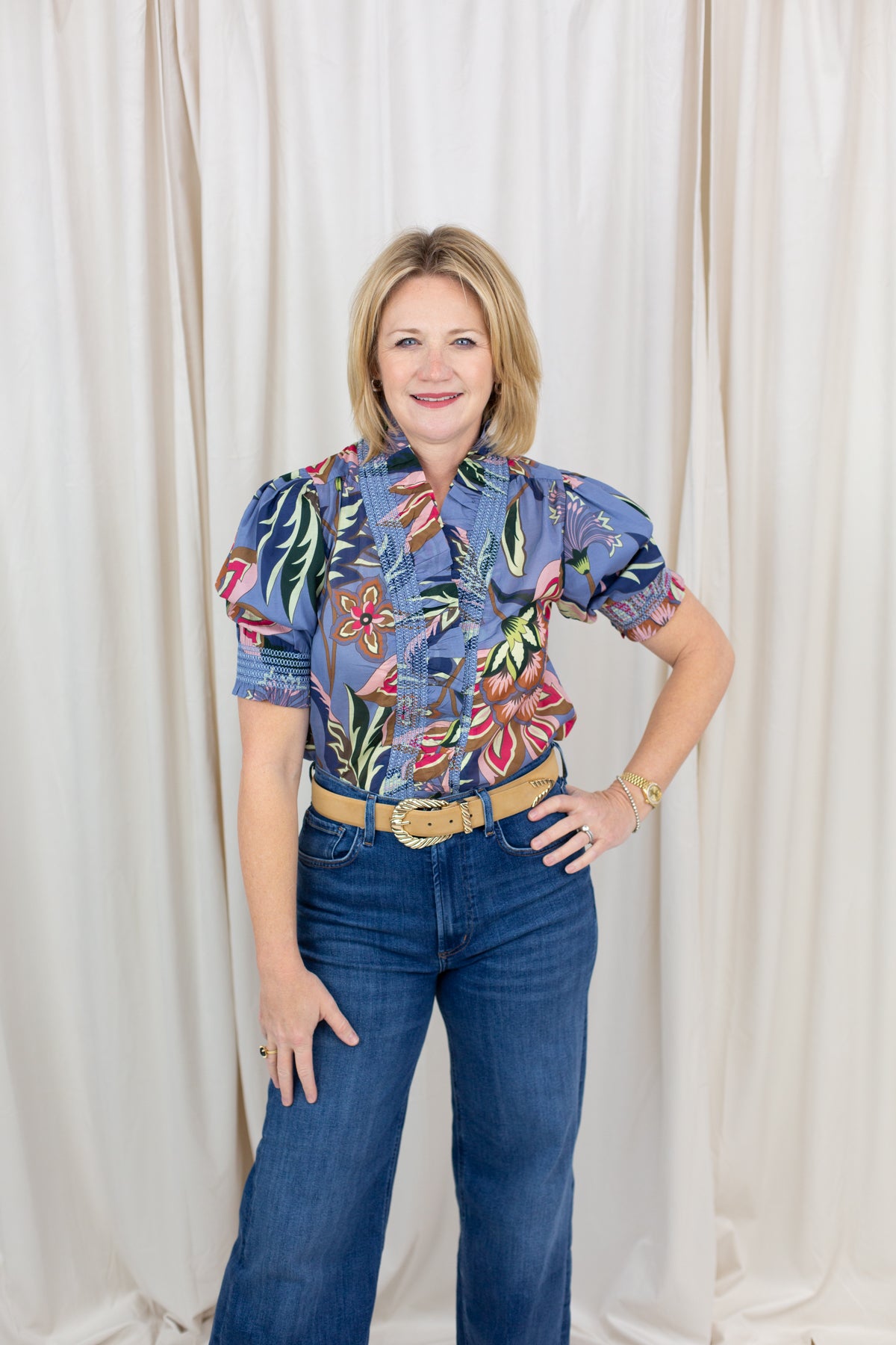 Woman wearing a short sleeve printed blouse in blue tones with an easy, relaxed fit