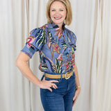 Woman wearing a short sleeve printed blouse in blue tones with an easy, relaxed fit