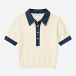 Polo with denim trim on white background.