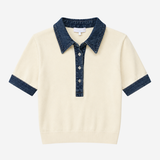 Polo with denim trim on white background.