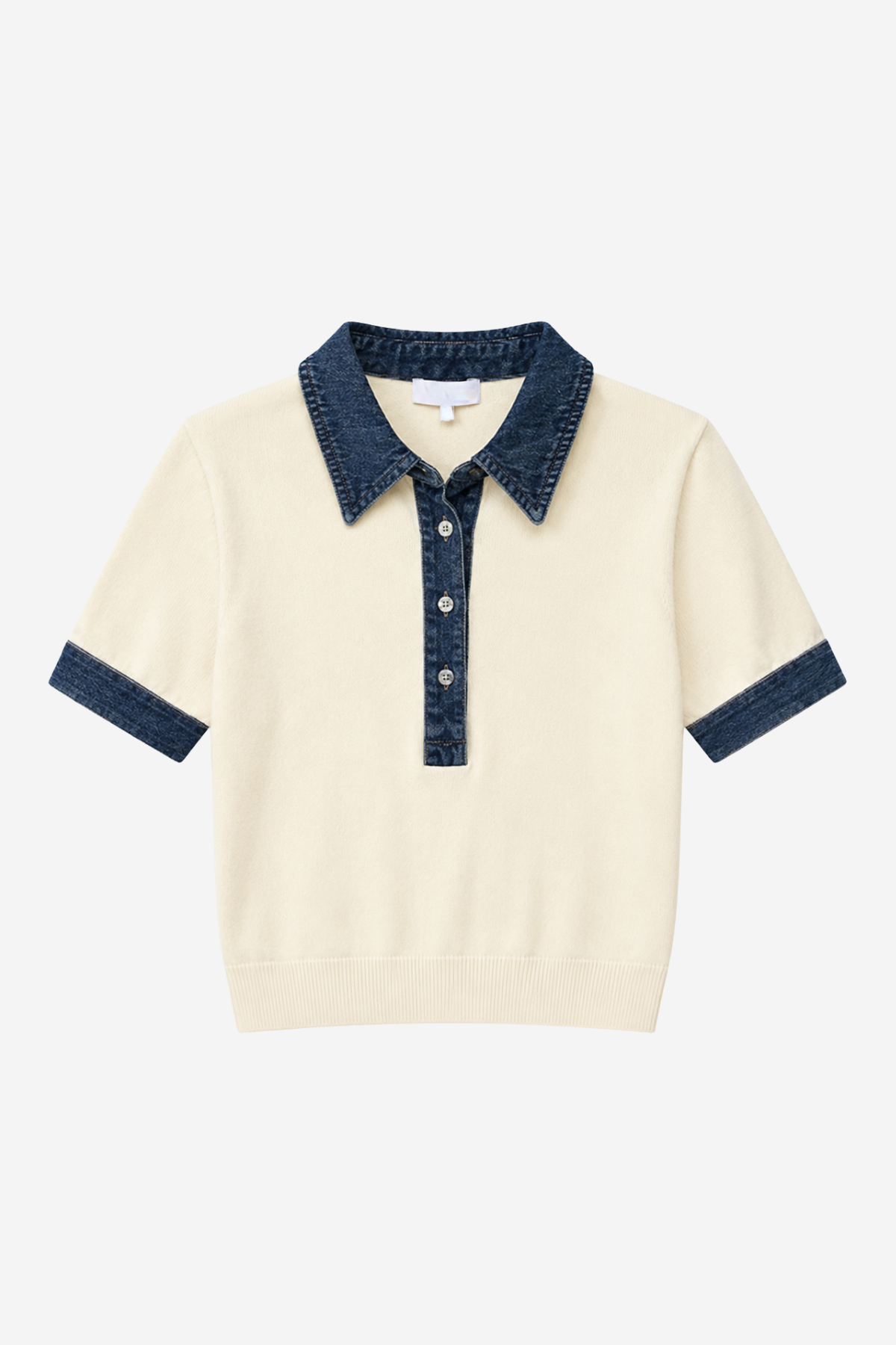 Polo with denim trim on white background.