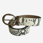 A snakeskin-patterned leather belt with a black and white python print and a bronze-tone metal buckle, coiled on a light gray background.