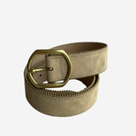 A light beige suede belt with a prominent gold-tone metal buckle, coiled on a plain light gray background.