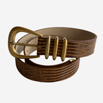 A brown textured leather belt with a gold-tone metal buckle and matching gold-tone decorative accents, coiled on a light gray background.