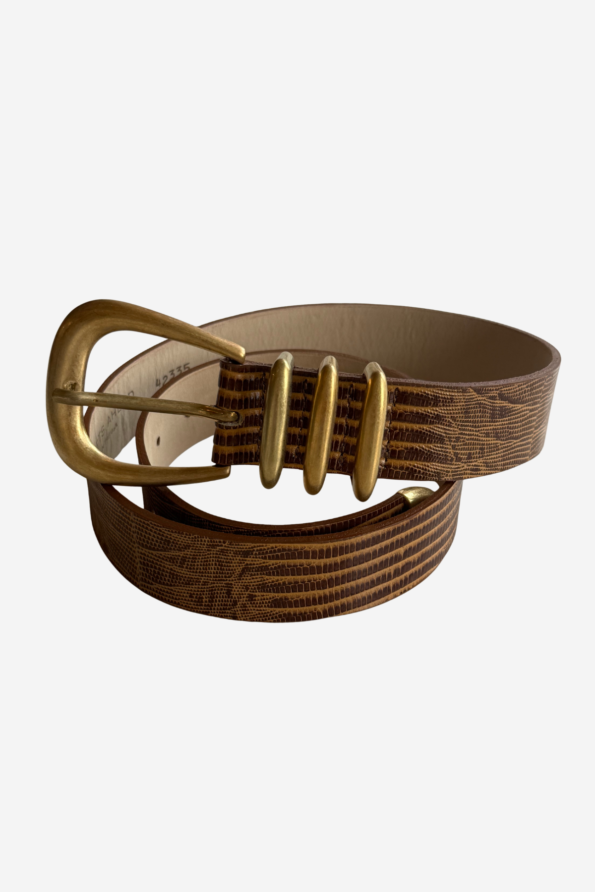 A brown textured leather belt with a gold-tone metal buckle and matching gold-tone decorative accents, coiled on a light gray background.
