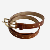 Brown belt with gold studs on plain white background